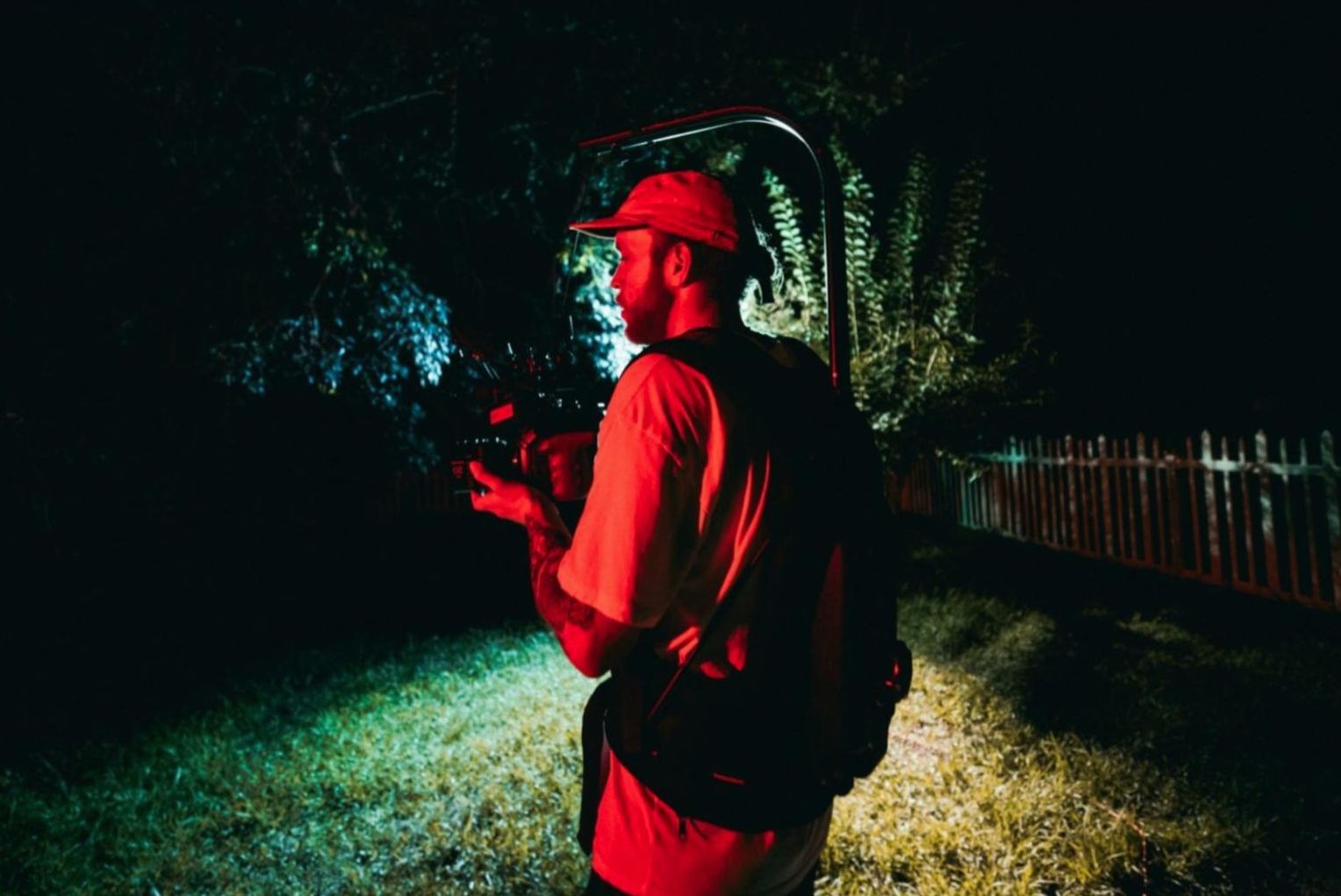 Photographer adjusting a reflector in outdoor conditions